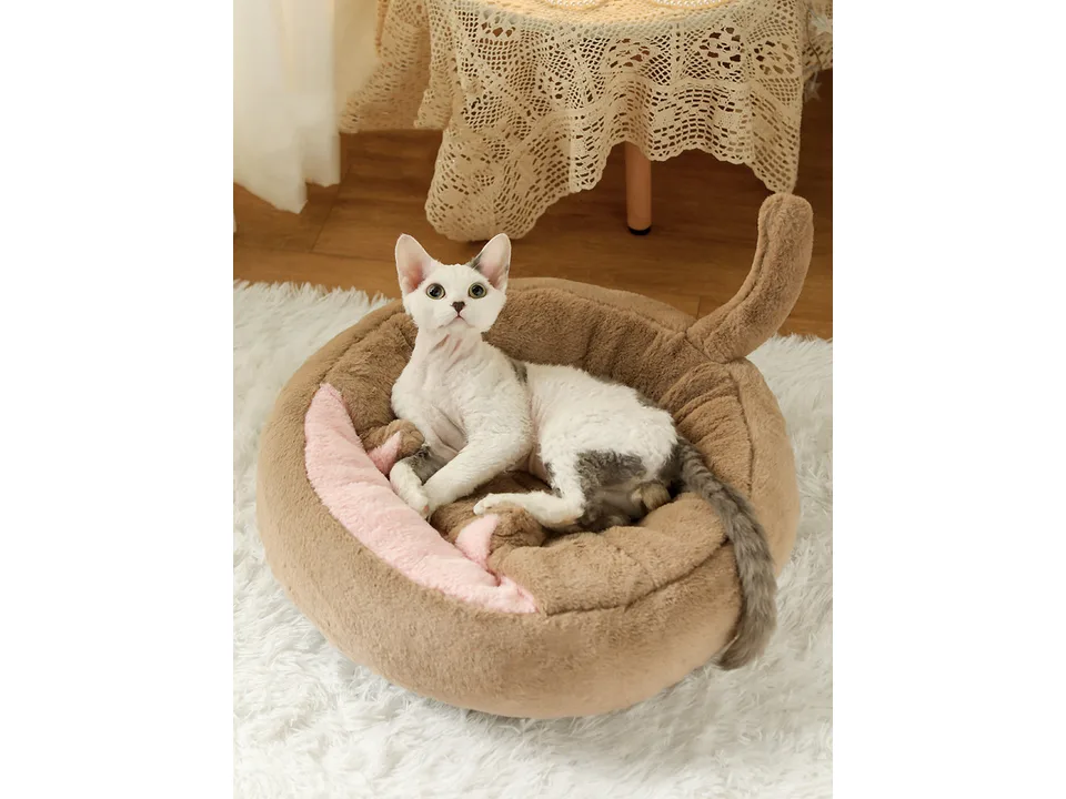 A cat resting inside a brown plush enclosed pet bed cave.