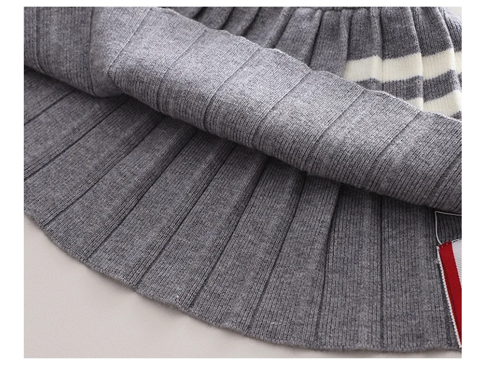 Close-up of the bottom hem of the pleated skirt.