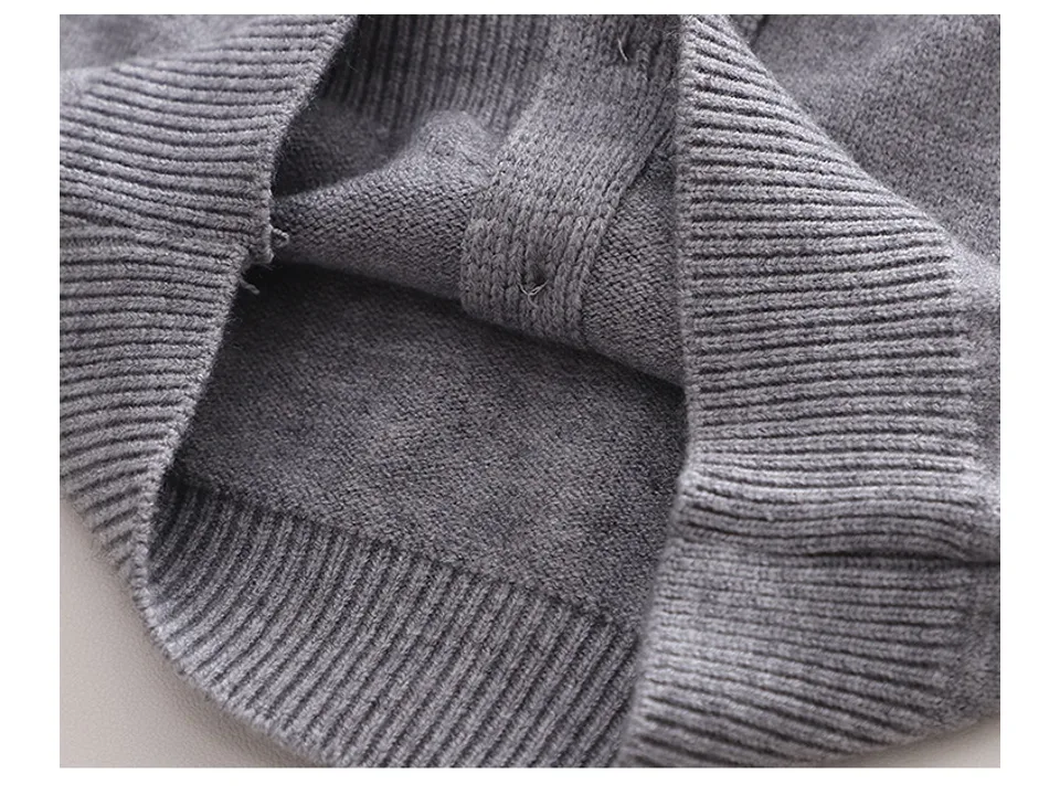 Close-up of the inside of the knitted sweater showing the stitching and fabric texture.