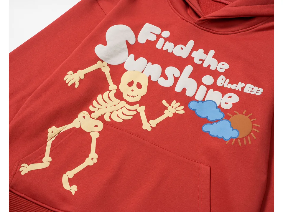 Close-up of the skeleton graphic and 'Find the Sunshine' text on the red sweatshirt.