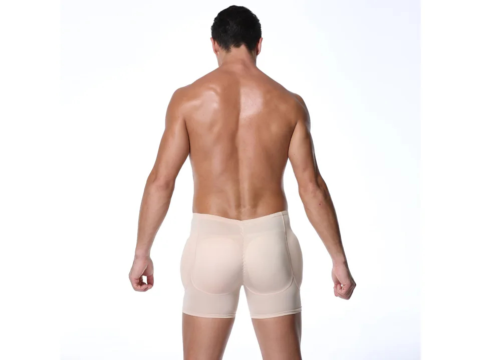 A man wearing beige compression shapewear shorts, viewed from the back.
