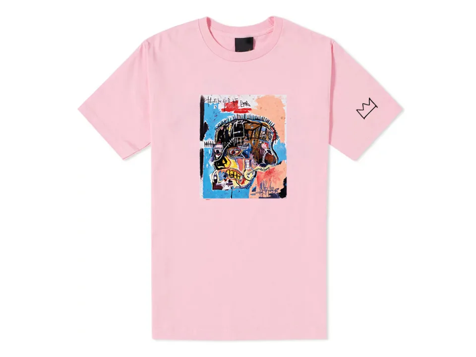 Pink t-shirt with an abstract face graphic print and a crown logo on the sleeve.