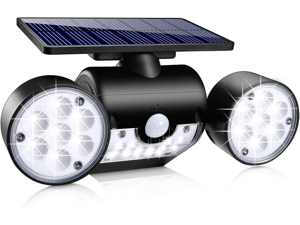 Solar garden light with dual heads and motion sensor, illuminated.