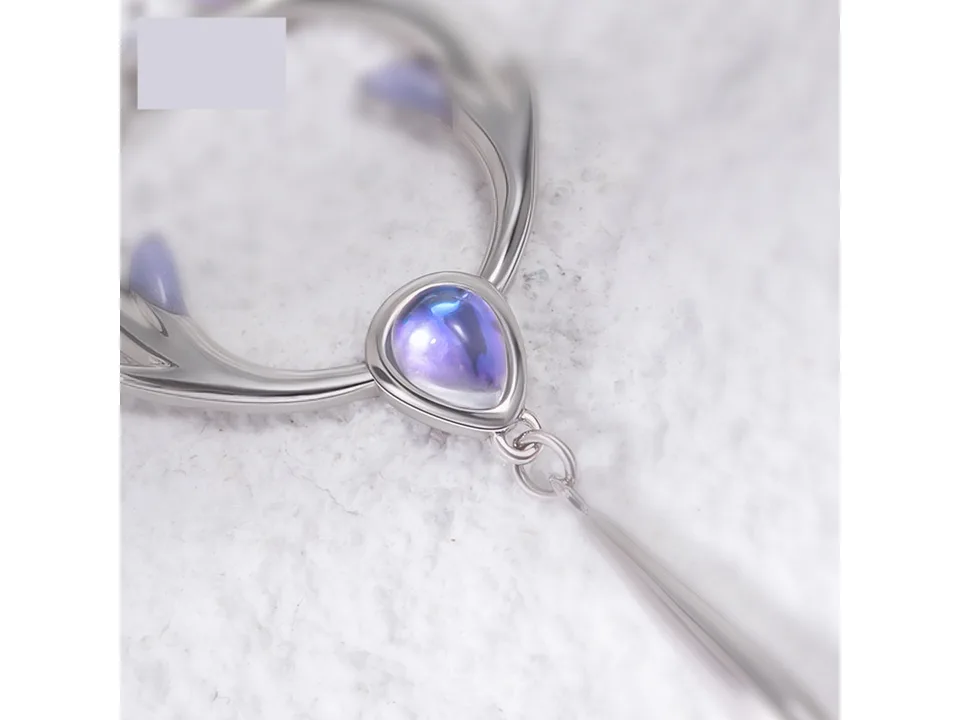 Close-up of the deer antler pendant with a blue gemstone accent