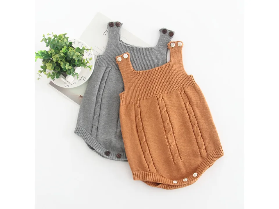 Two baby knit rompers, one grey and one brown, laid out together.