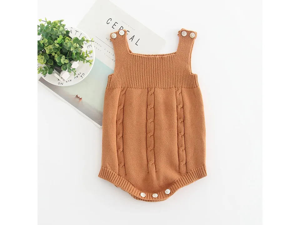 A brown sleeveless baby knit romper with cable knit details.