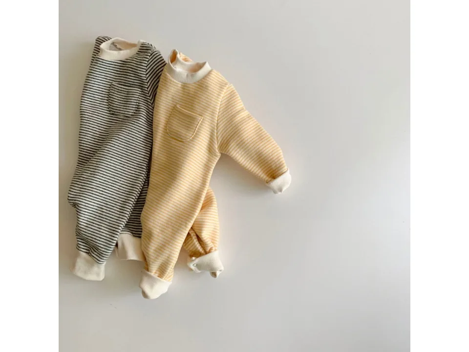 Two baby jumpsuits, one yellow striped and one grey striped, laid flat on a white background.