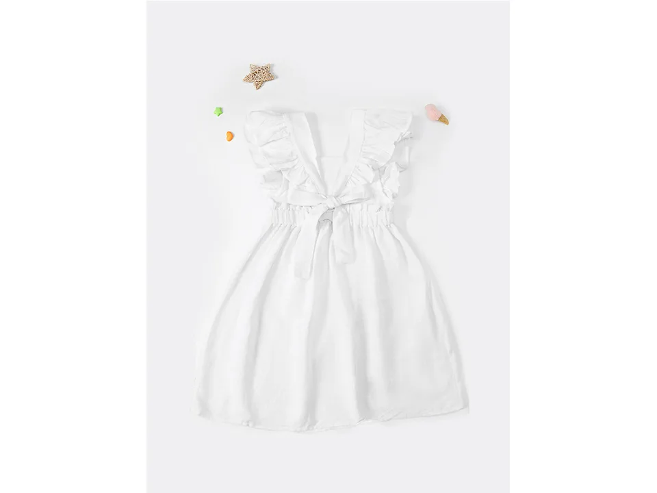 Full view of the white girls' A-line dress with ruffled straps and a bow.