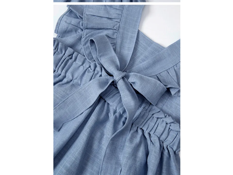 Close-up of the blue dress bodice showing the bowknot and ruffled straps.