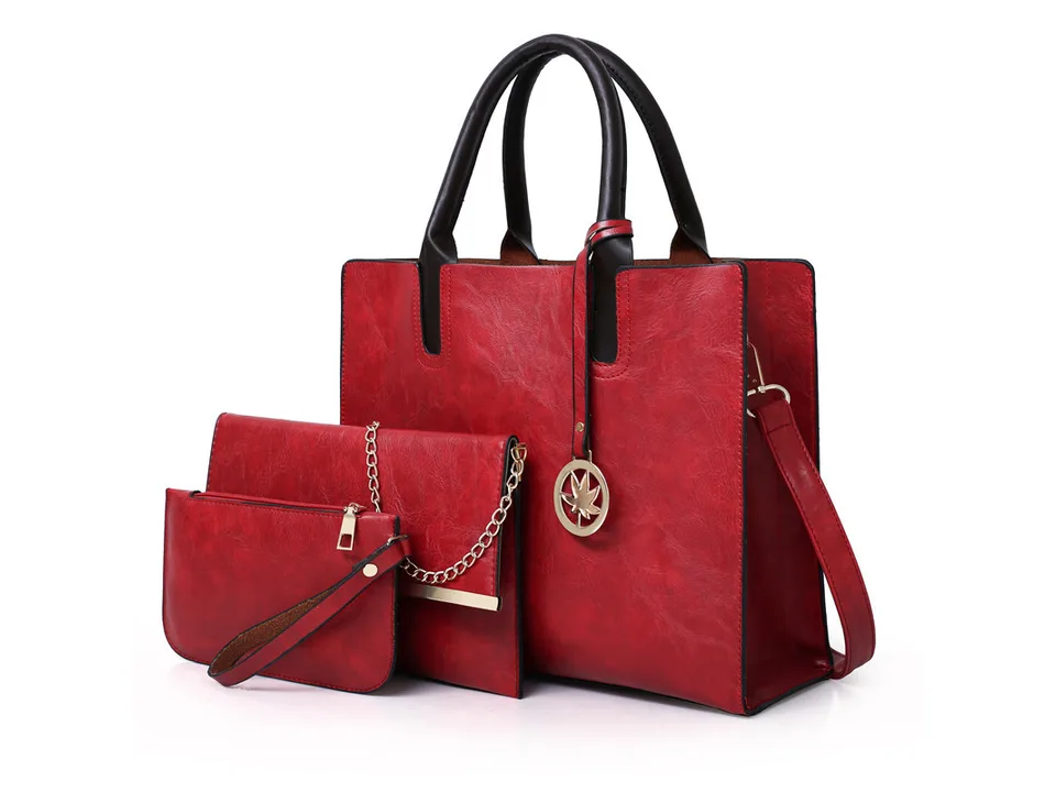 Red handbag set including a tote, a clutch with a chain, and a wristlet.