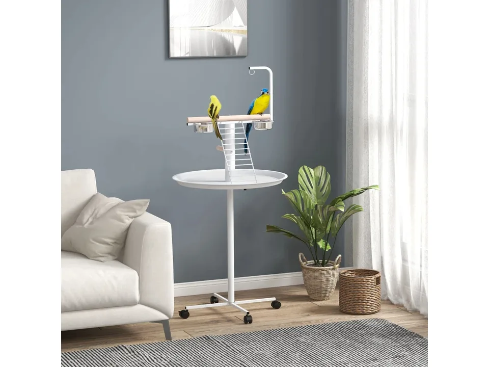 Bird play stand with two parrots on it, placed in a living room next to a sofa.