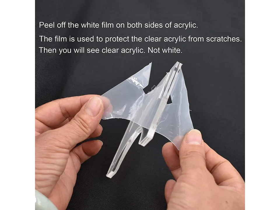 Hands peeling protective film off the clear acrylic bracket.