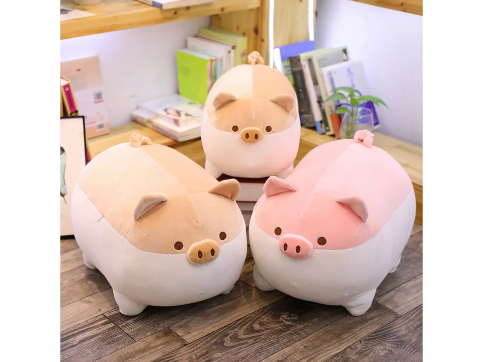 Two pig plush toys, one pink and one tan, sitting together.