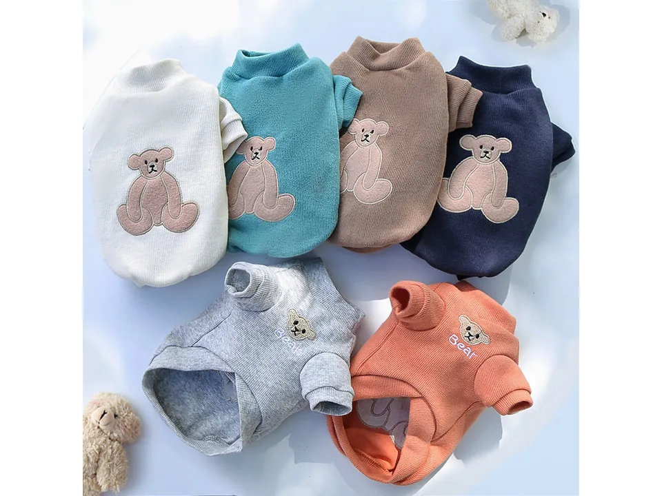 A collection of six pet shirts in different colors, each with a bear embroidery.