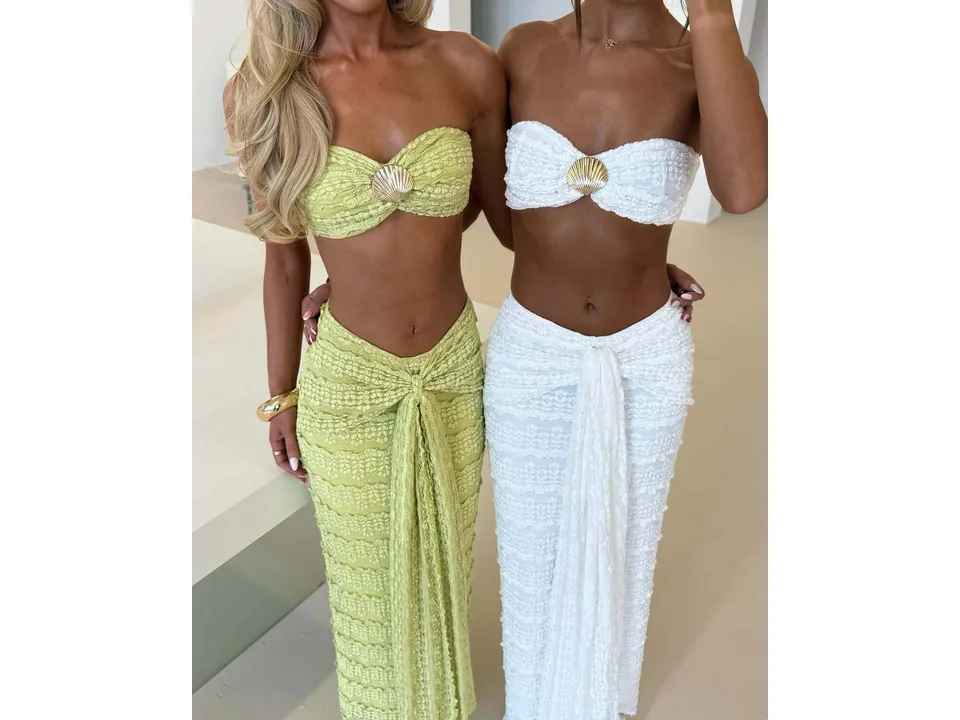 Close-up of two women wearing lime green and white lace two-piece sets.