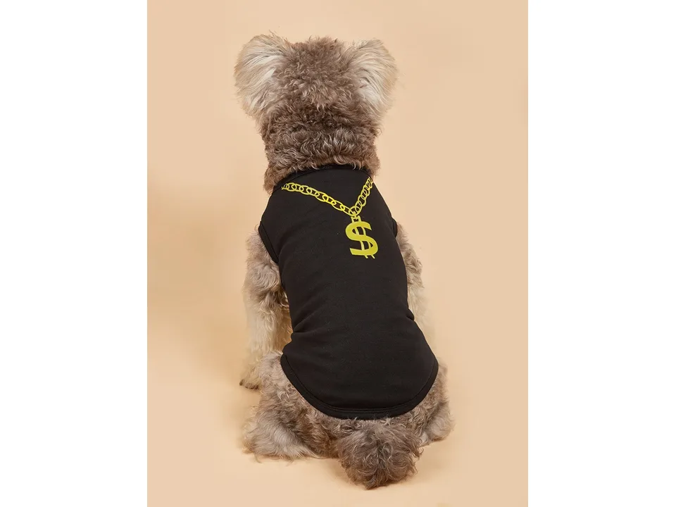 A dog wearing the black dog vest with a gold chain print, viewed from the back.