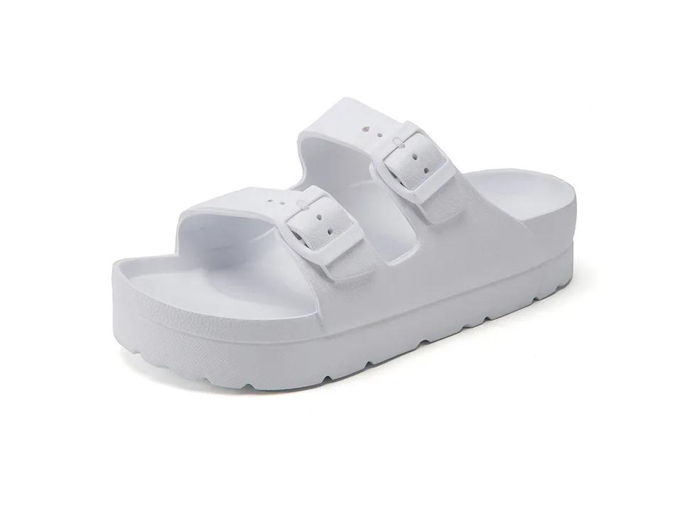 White platform slide sandals with white buckles