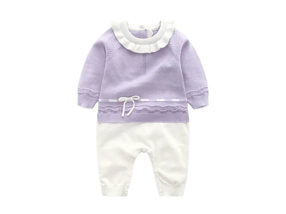 Purple baby girl knitted jumpsuit with ruffled collar and white bow detail.