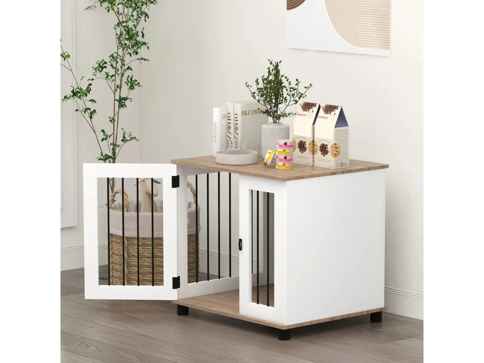 Dog crate end table in a living room with the door open and decor on top.