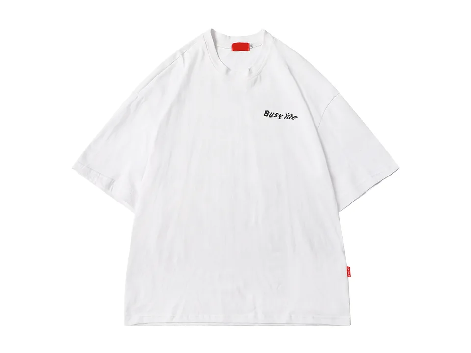 White oversized t-shirt with small black text on the chest.