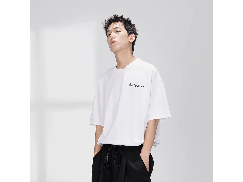 A man wearing the white t-shirt.