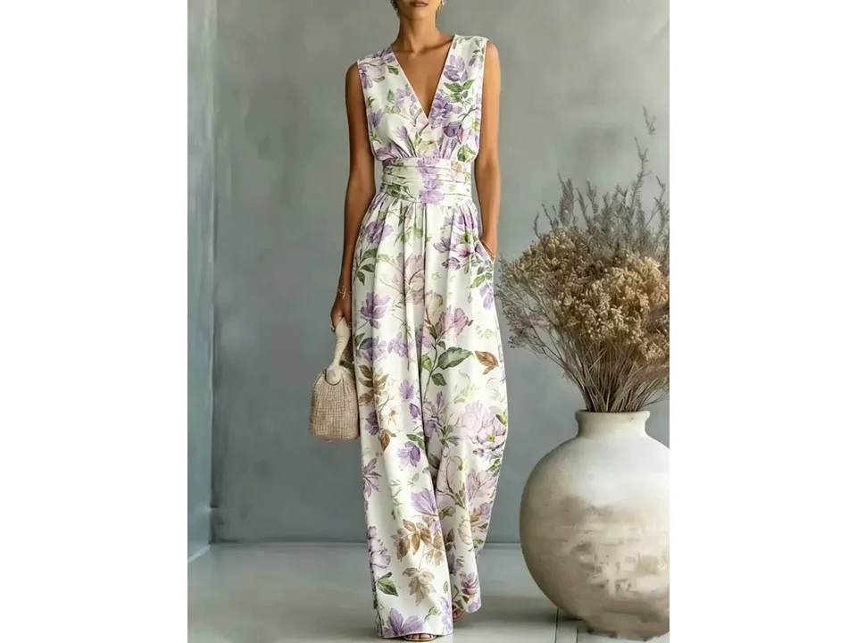 A woman wearing a sleeveless V-neck wide-leg jumpsuit with a purple floral pattern.