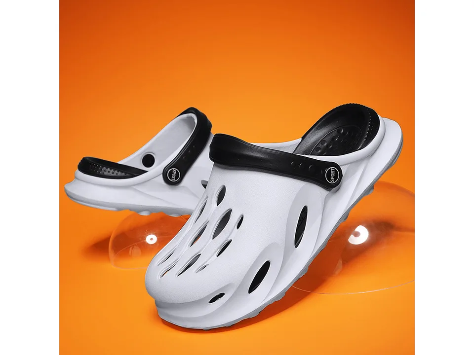 White EVA clog slipper with black strap on an orange background.