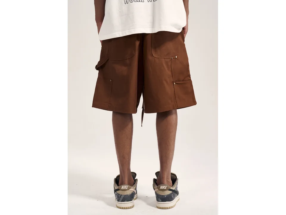 Back view of brown cargo shorts with pockets on a person.