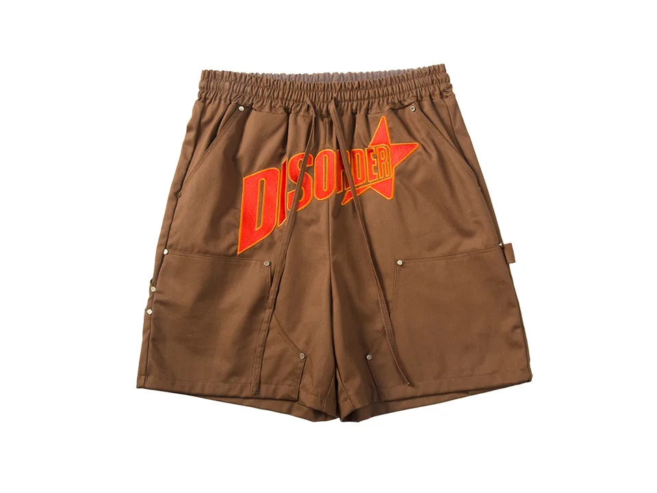Studio shot of brown cargo shorts with 'DISORDER' embroidery.