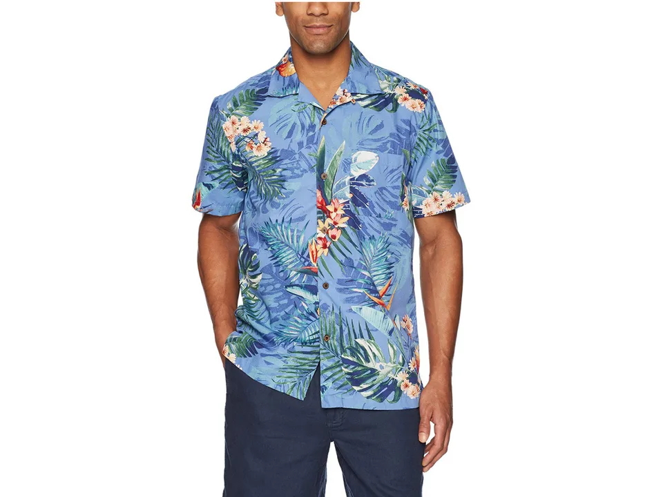 A man wearing the blue tropical print short-sleeve button-down shirt.
