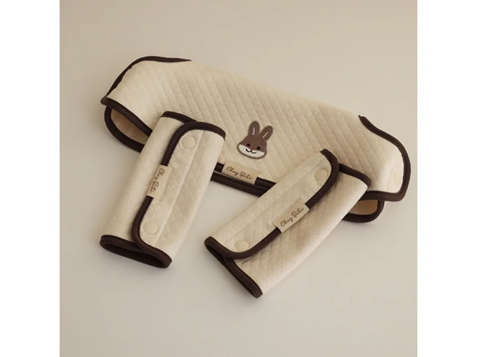A set of baby carrier shoulder strap covers and a chest cover with a rabbit embroidery.