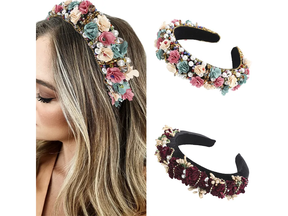 A woman wearing a floral and pearl embellished bridal headband.