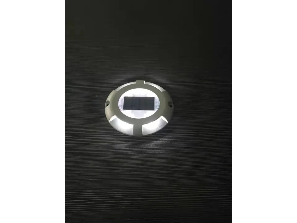 A single solar ground light illuminated in the dark.