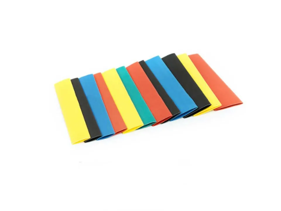 A selection of colorful heat shrink tubing pieces laid out in a row.