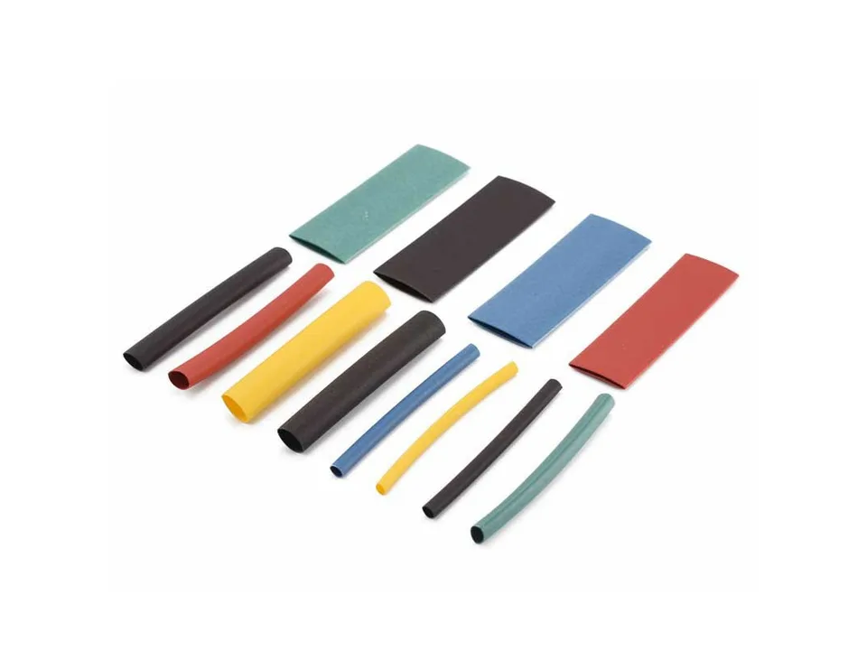 Various sizes and colors of heat shrink tubing arranged on a white background.