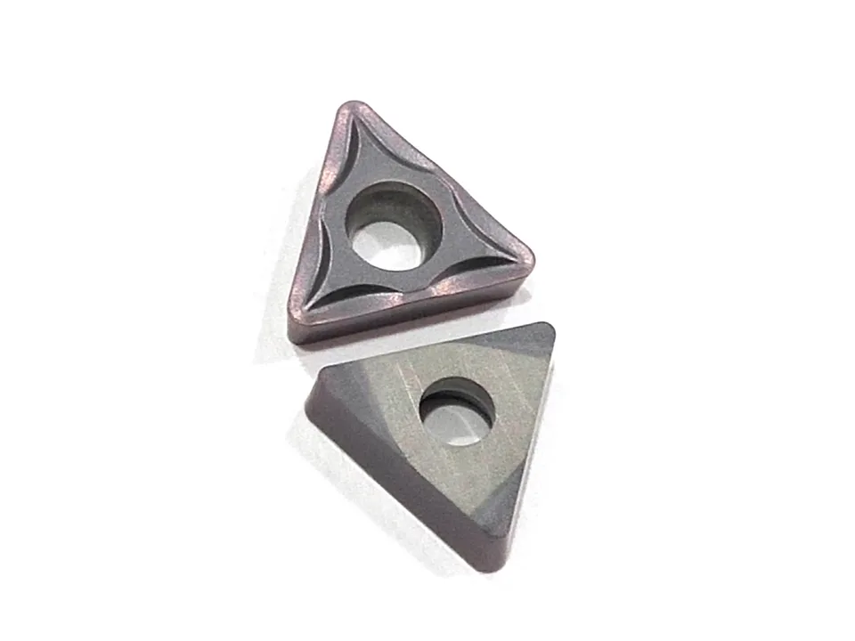 Two triangular tungsten carbide CNC lathe cutting blades shown from different angles.
