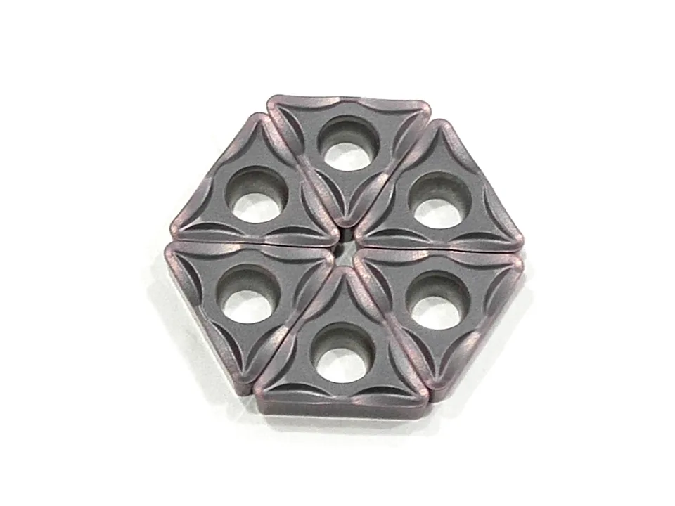 Six triangular CNC lathe cutting blades arranged in a hexagonal pattern.
