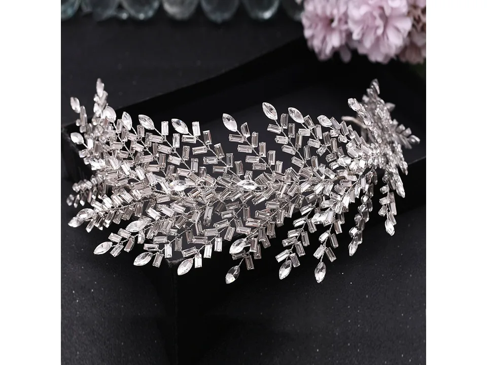 A detailed view of a crystal bridal hairband with leaf and baguette stone patterns.