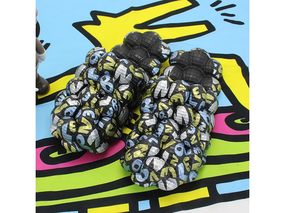 Black bubble slides with colorful letter pattern.