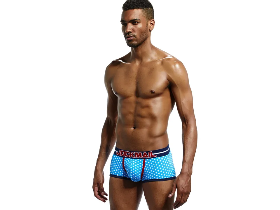 Front view of a man wearing blue star-print boxer briefs