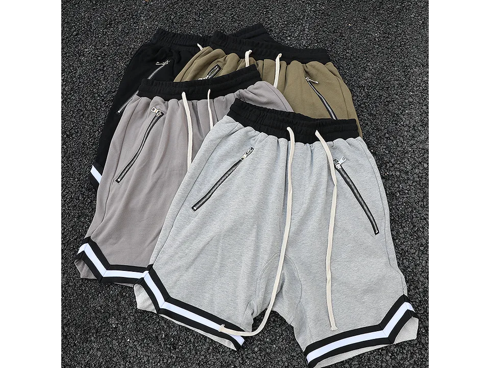 A collection of drawstring sweatshorts in black, olive, grey, and light grey colors.