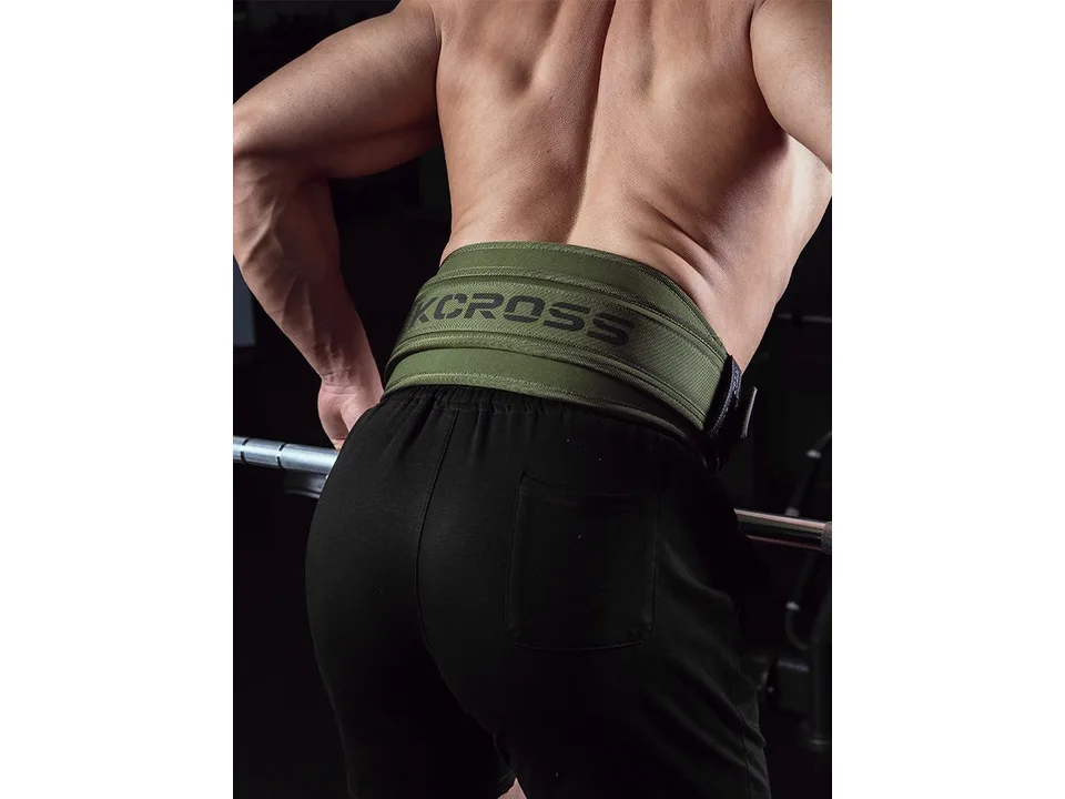 A man wearing a green weightlifting belt from the back view.