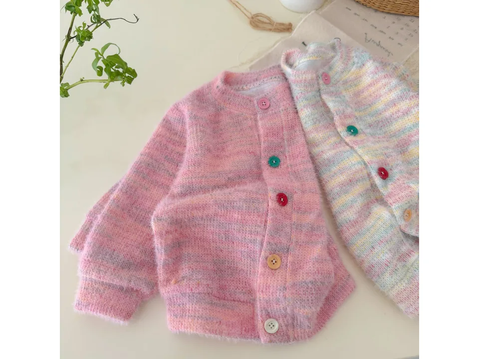Two knit cardigans, one pink and one multi-colored, laid side-by-side.