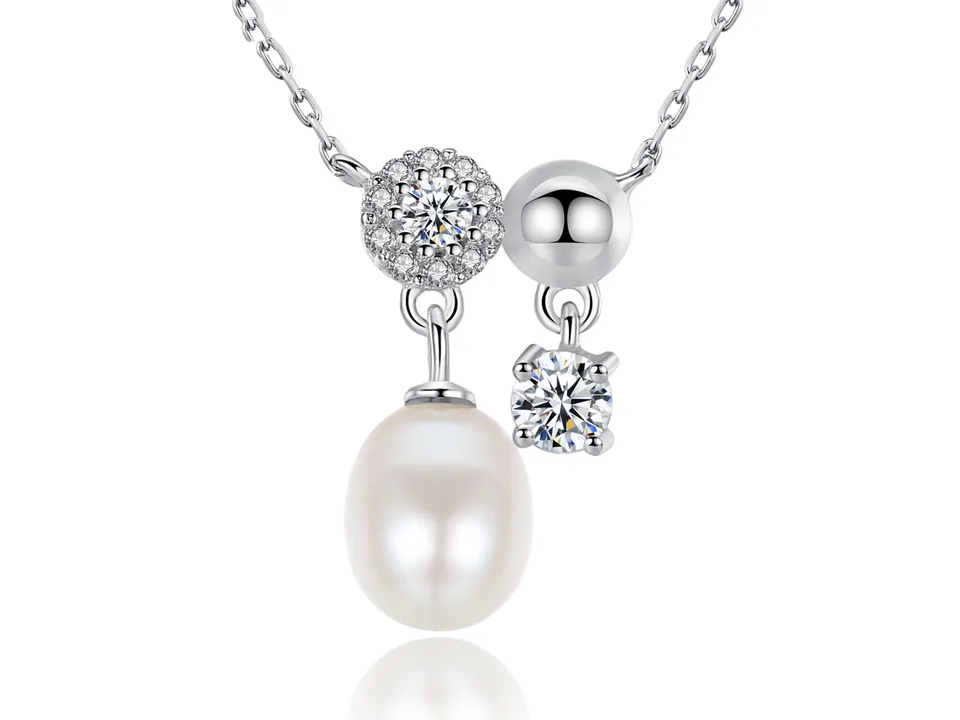 A silver necklace with a pearl pendant and geometric crystal accents.
