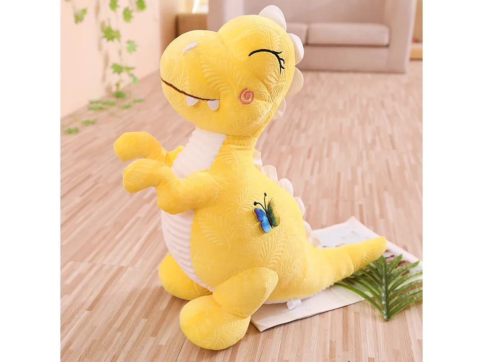 Yellow dinosaur plush toy with a butterfly detail.