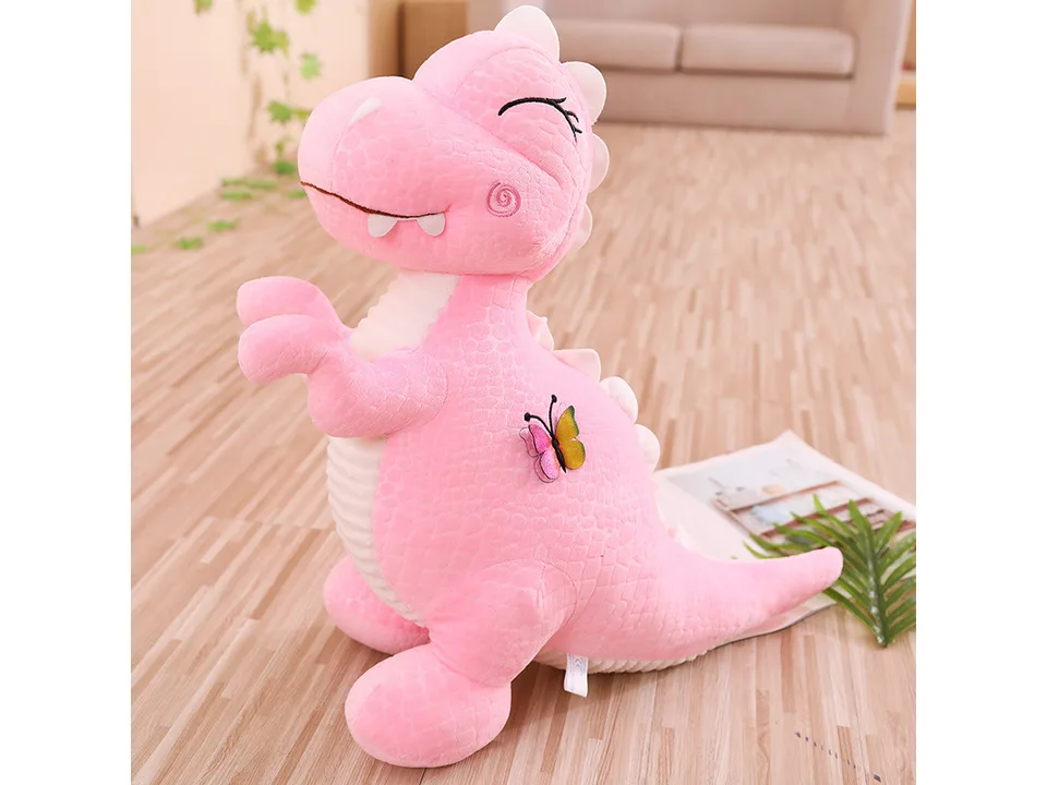 Pink dinosaur plush toy with a butterfly detail.