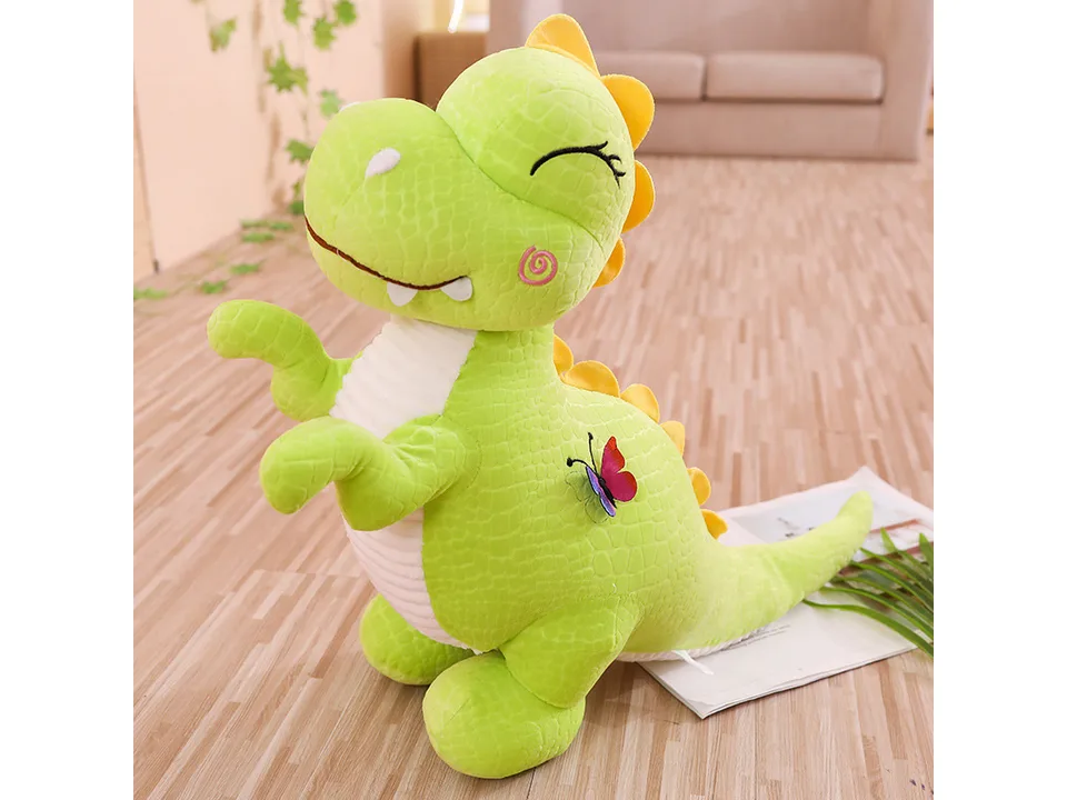Green dinosaur plush toy with a butterfly detail.