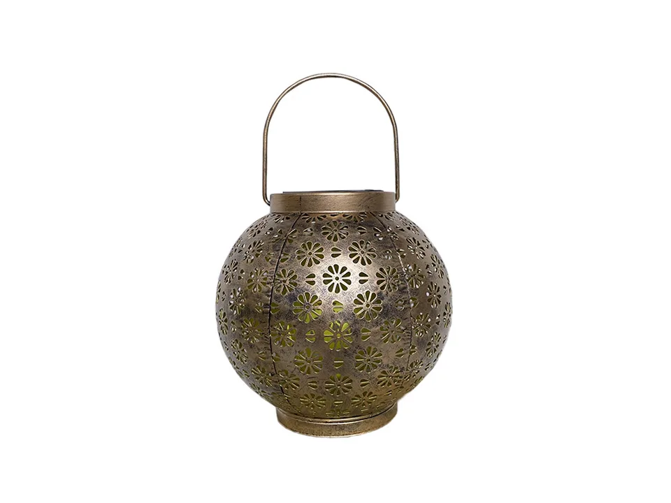 A round, bronze-colored metal solar lantern with a floral cutout pattern and a handle.