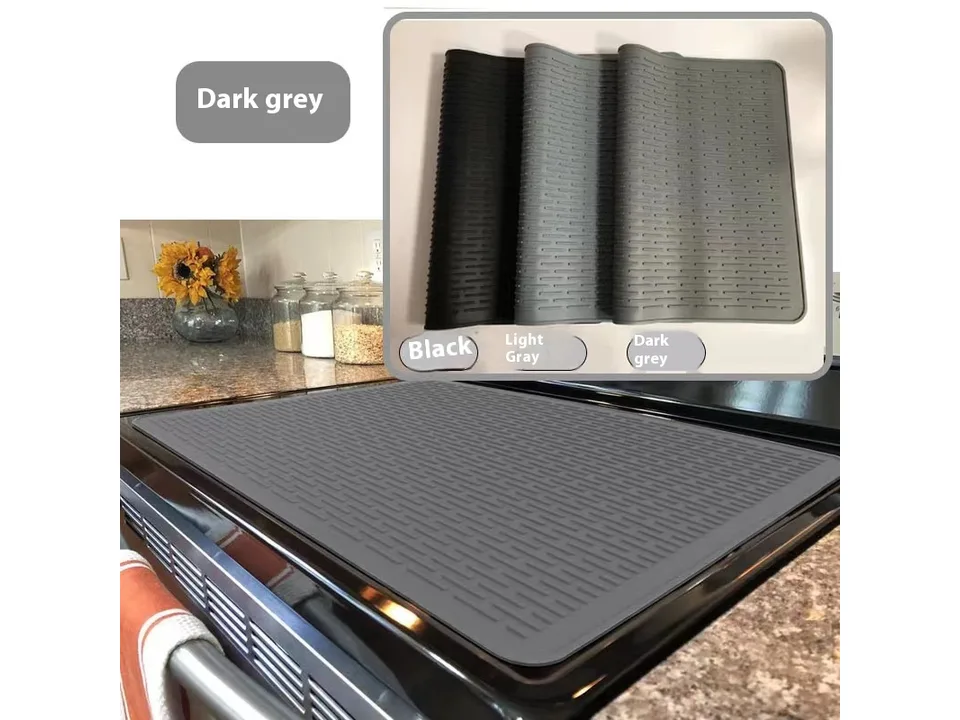 A grey silicone mat on a stove with a color selection guide showing black, light grey, and dark grey options.