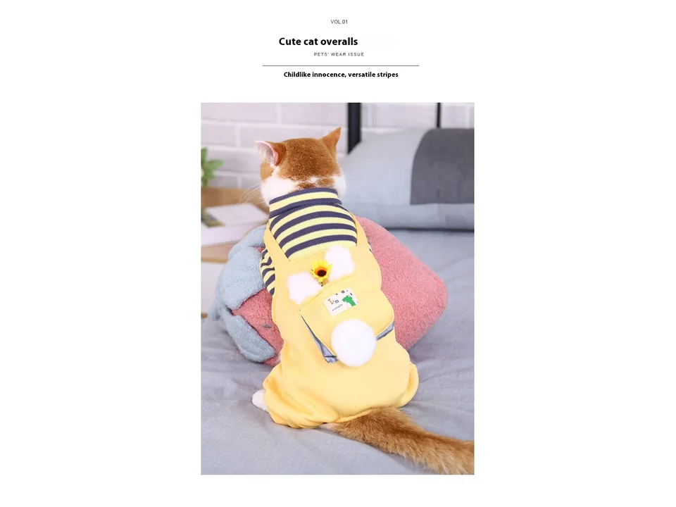 A cat wearing yellow striped pet overalls with a small backpack detail.